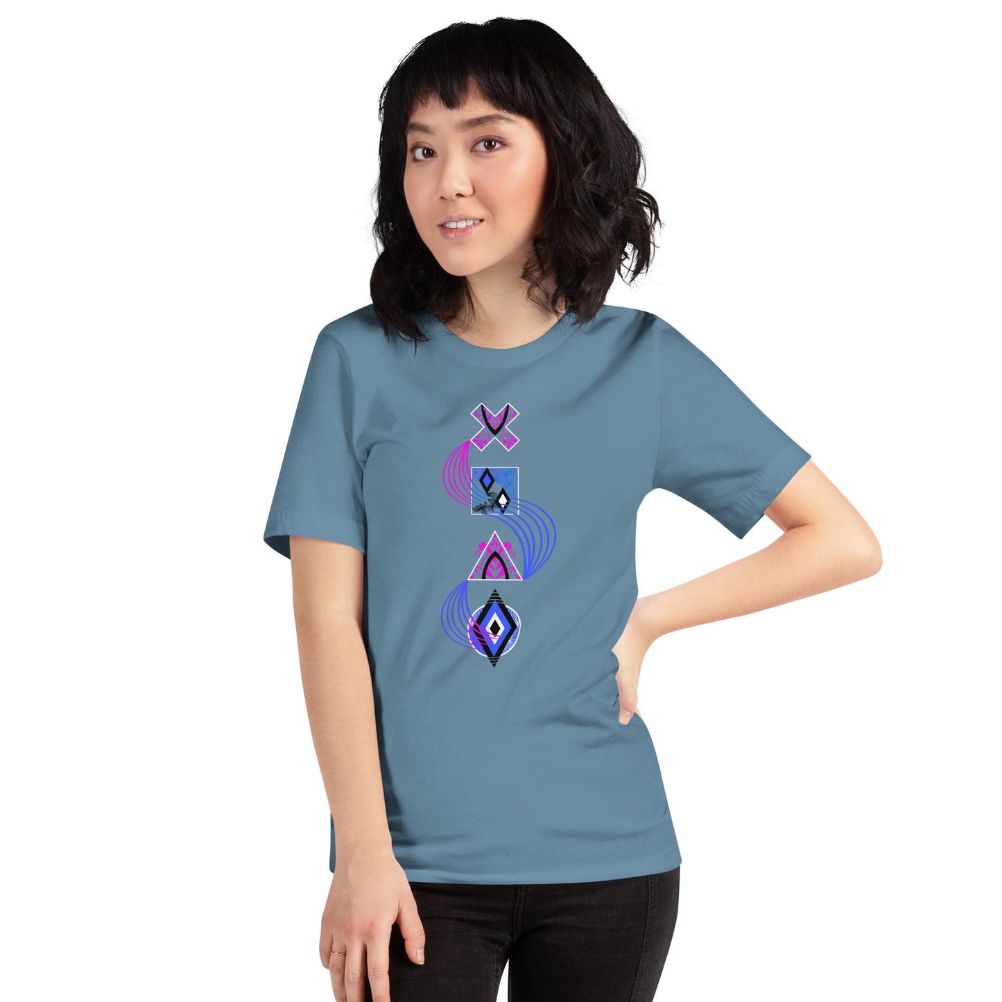 Steel blue unisex PlayStation controller symbols t-shirt with neon blue and pink swirl linking stylized cross (×), square (□), triangle (△), and circle (○) icons. Standing in front of a brick wall.