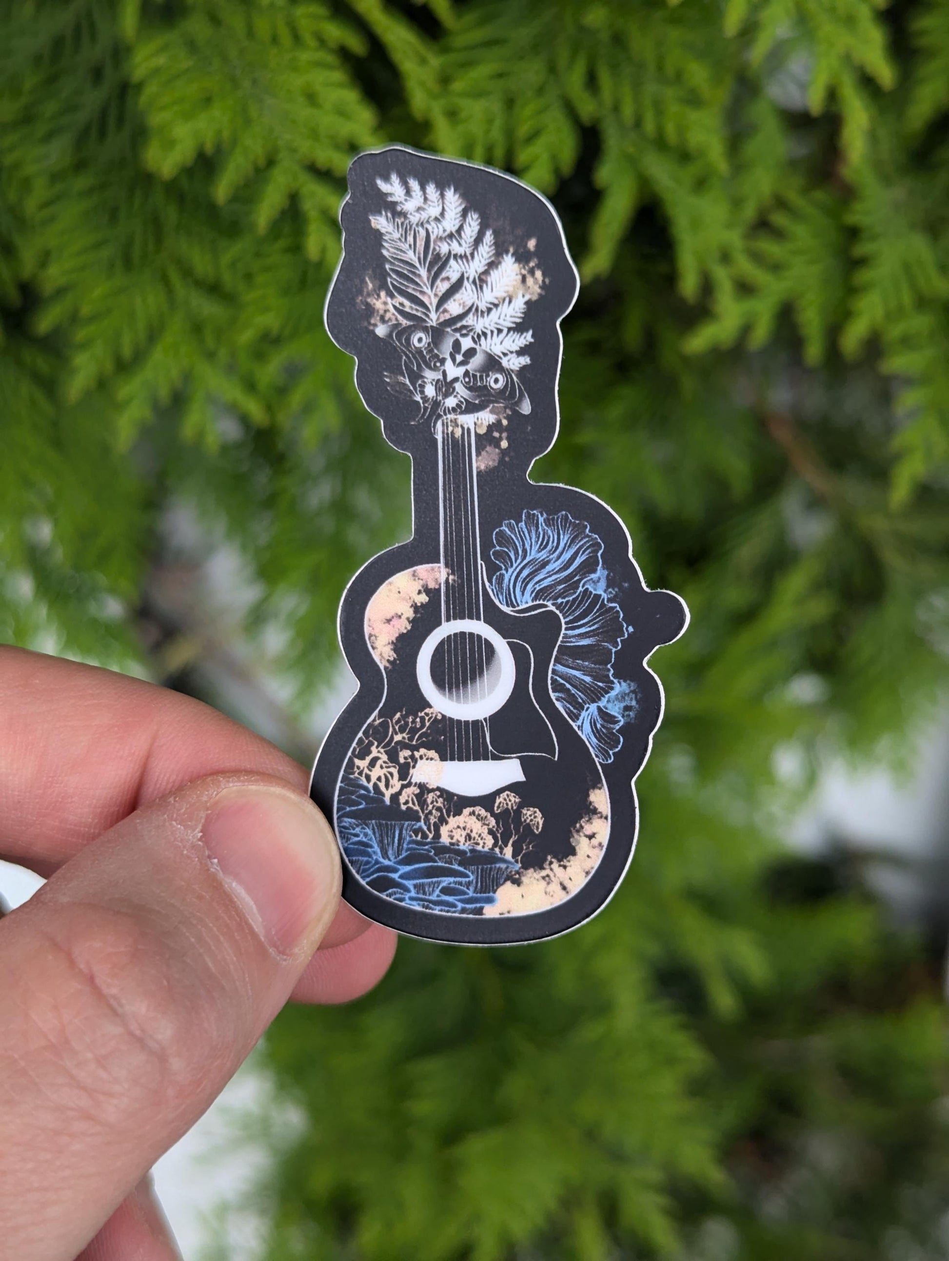 Vinyl sticker fan art of Joel & Ellie&#39;s guitar from the Last of Us (TLOU). Guitar is outlined in white and has cordyceps mycella around it. Neck of guitar is replaced by Ellie&#39;s tattoo.